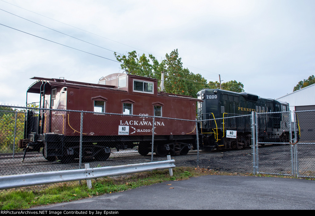 A Lackawanna Caboose and a PRR Geep sit outside the URHS Shops 